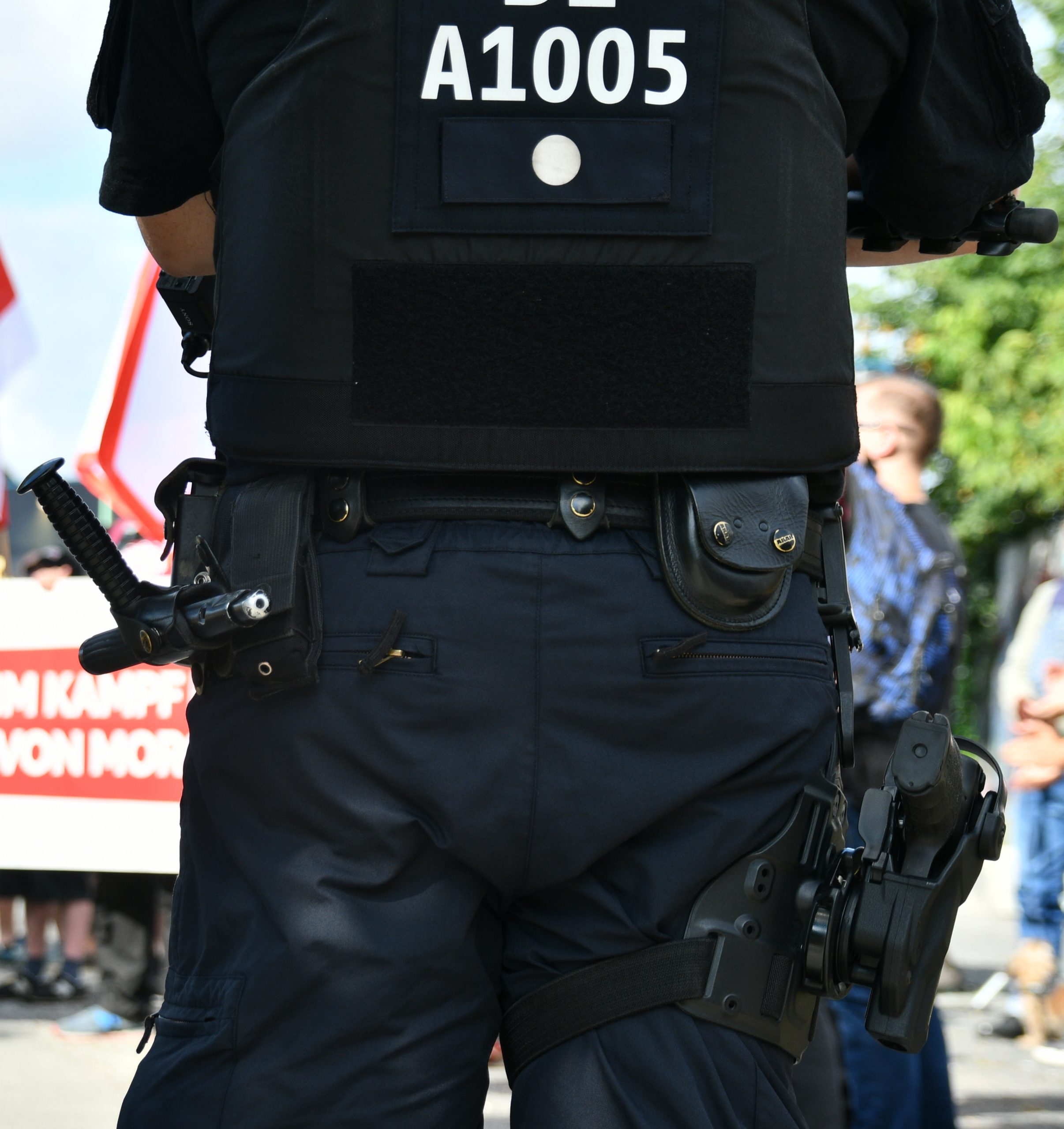 Hüfte eines Cops mit Tonfa und Dienstwaffe